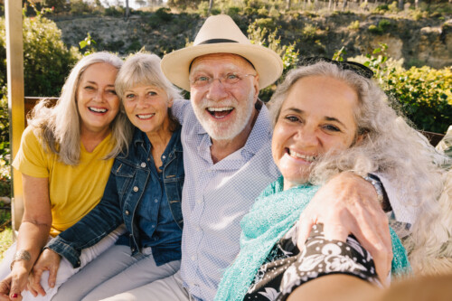 iStock-1378773750-500x333 Excited senior friends taking a selfie together during vacation