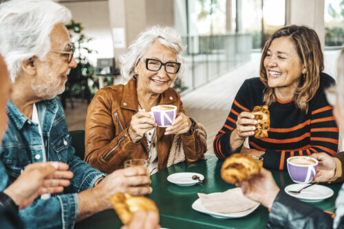 iStock-2151440593-2-500x333 Happy senior people having breakfast sitting at cafe bar - Group of older friends having lunch at restaurant table - Food and beverage life style concept